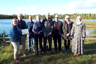 Members of the Saxilby Nature Project holding the Lincolnshire Environmental Award 2022