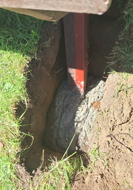 cement at the base of the picnic bench