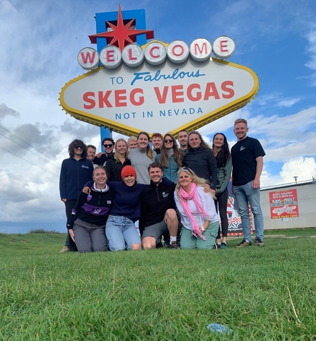 Interns next to skeg vegas sign