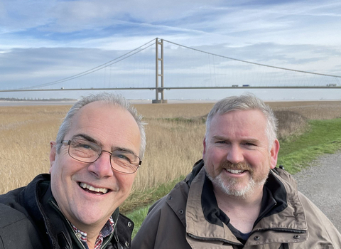 Wilder Lincolnshire podcast presenter team in front of the Humber Bridge at Far Ings